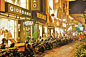 Tourists at the illuminated shops in the evening, Kuta, Bali, Indonesia, Asia