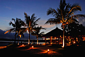 Restaurant behind palm trees at Mimpi Resort in the evening, Menjangan, Western Bali National Park, Indonesia, Asia