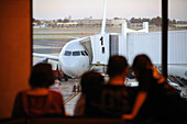 Aeroplane, Aeroplanes, Aircraft, Aircrafts, Airplane, Airplanes, Airport, Airport terminal, Airport terminals, Airports, back view, Boarding bridge, Color, Colour, Daytime, exterior, Four, Four persons, human, outdoor, outdoors, outside, people, person, p