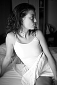 Adult, Adults, Attention, Attentive, b&W, Bed, Bedroom, Bedrooms, Beds, black-and-white, Brunette, Brunettes, Contemporary, Dark-haired, Facial expression, Facial expressions, Female, human, In bed, indoor, indoors, interior, Lean, Leaning, Long hair, Lon