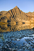 Peaks of the Tombstone Range reflected in Grizzly Lake, Tombstone territorial Park, Yukon, Canada