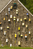 Wall of buoys on the side of a cottage in Orleans, Cape Cod, Massachusetts, USA