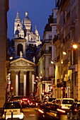 The night view of Sacre-Coeur Church from a street. Paris. France