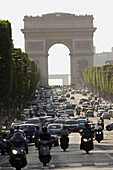 Traffics on Avenue des Champs-Elysees with Arc de Triomphe in the background. Paris. France