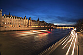 The night view of Conciergerie with River Seine in foreground. Paris. France