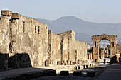 The main avenue of ancient ruin city of Pompei. Campania. Italy
