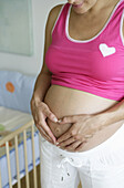 Pregnant woman touching belly, Styria, Austria
