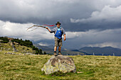 Dairy farmer and shepherd with a whip in an alpine meadow, Goaslschnoellen, Rittner Horn, South Tyrol, Italy