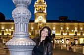 Italy, Parma, girl standing on Piazza Giuseppe Garibald in backgorund Palazzo del Governatore