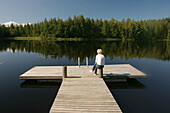 Woman in a lake. Lapland. Forest of the north of Finland.