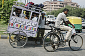 Delhi, India: young students driver and his 'taxi'
