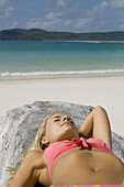 Woman sunbathing.  Whitehaven Beach, Australia.