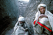 Old people pray outside of the rock carved chruches of Lalibela.