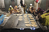 Volunteers cook chapatis in the Golden temple's kitchen, Amritsar, India