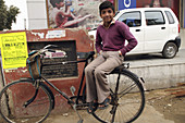 Waiting for his friend  This Indian boy takes it easy on his friend's bicycle in a small town in Punjab, India