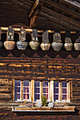 Row of cow bells, mountain restaurant Aebi, Adelboden, Bernese Oberland, Canton of Berne, Switzerland