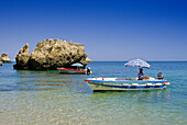 Excursion boats off the beach under blue sky, Praia de Dona Ana, Algarve, Portugal, Europe
