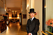 Doorman wearing a top hat in front of the lobby of the Savoy Hotel, Florence, Tuscany, Italy, Europe