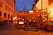 Tables outside the Olde Hansa Restaurant, which serves medievel dishes, evening, Tallinn, Estonia