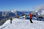 Two skiers downhill skiing on slope, Rosskopf, Spitzing, Bavarian Alps, Bavaria, Germany