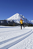 Woman cross-country skiing, Hohe Munde in background, Leutasch, Tyrol, Austria