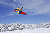 Snowboarder in mid-air, ski area Soelden, Oetztal, Tyrol, Austria