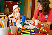 Girl, 5 years old, and young woman, care assistant, drawing in the kids club, Lamaya Resort, Coraya, Marsa Alam, Red Sea, Egypt