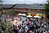 China  Yunnan Province  Lijiang  The Old Town  Naxi minority women dancing in Sifang Square