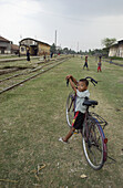 Children playing along the tracks of a train station, Phnom Pehn, Cambodia