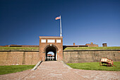 USA, MD, Baltimore. The arched entrance into the fortified walls of Fort McHenry is the only way in and out.