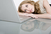 Businesswoman using laptop at desk