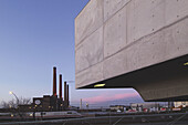 Phaeno Science Center (architect: Zaha Hadid), Volkswagen car factory in background. Wolfsburg, Lower Saxony, Germany