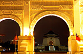 View through the illuminated entrance gate at Chiang Kai-shek Memorial Hall at night, Taipei, Taiwan, Asia
