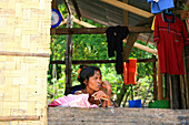 Sea gypsy, Moken woman smoking, Mergui Archipelago, Andaman Sea, Myanmar, Burma, Asia