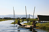 Intha people in their boats in front of stilt houses and floating gardens, Inle Lake, Shan State, Myanmar, Burma, Asia