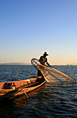 Intha fisherman with fish trap in the evening light, Inle Lake, Shan State, Myanmar, Burma, Asia