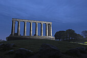 National Monument at dusk, replica of the Parthenon (it was designed in 1822 as a memorial to the Scots who died in the Napoleonic Wars), Calton Hill, Edinburgh. Lothian Region, Scotland, UK