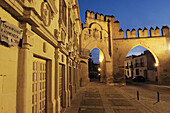 Escribanias publicas (now tourism office) and Jaen town gate at dusk in Populo square, Baeza. Jaen province, Andalucia, Spain