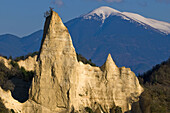Mountains in South Bulgaria, hoodoo rocks of Melnik, and snow-covered peak of Pirin mountains, Bulgaria