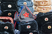 Sofia, capital of Bulgaria, flea market, Russian fur caps with hammer and sickle, remnants of communist era, Bulgaria