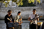 France. Paris. A band play on the bank of River Seine under later afternoon sunlight during Paris Plage.