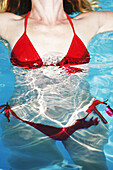 30 year old woman wearing red bikini