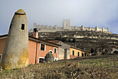 View to the Peñafiel castle, in the Valladolid province, Castilla Leon, Spain  This pillar is a chimney  The castle is in the top of the hill
