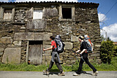 Pilgrims on the St. James Way near Santiago de Compostela. La Coruña province, Galicia, Spain