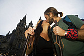 Pilgrims kissing in front of cathedral, Santiago de Compostela. La Coruña province, Galicia, Spain