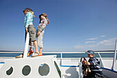Three children on a boat, Lake Starnberg, Bavaria, Germany