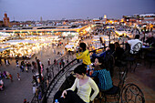 People at a cafe over Place Jemaa el-Fna in the evening, Marrakesh, South Morocco, Morocco, Africa