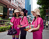 Orchard road, shopping zone, three nice girls posing in front of  Takashimaya shopping center  , Singapur Aisia