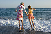 girl children on beach 2 sisters