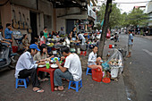 Vietnam  People eating at food stall on a street of Saigon